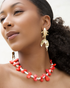 Model wearing koi fish statement earrings