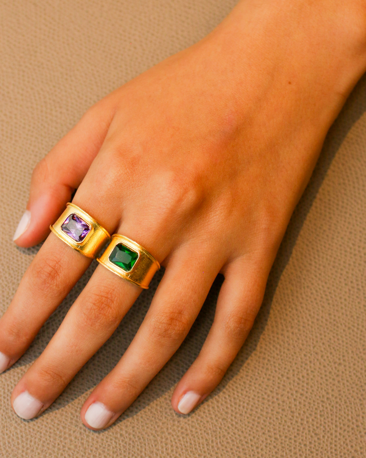Gold purple amethyst signet ring worn on hand