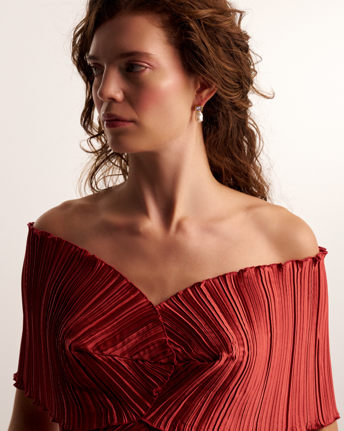 Woman wearing elegant pearl drop earrings