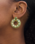Model wearing green donut hoop earrings