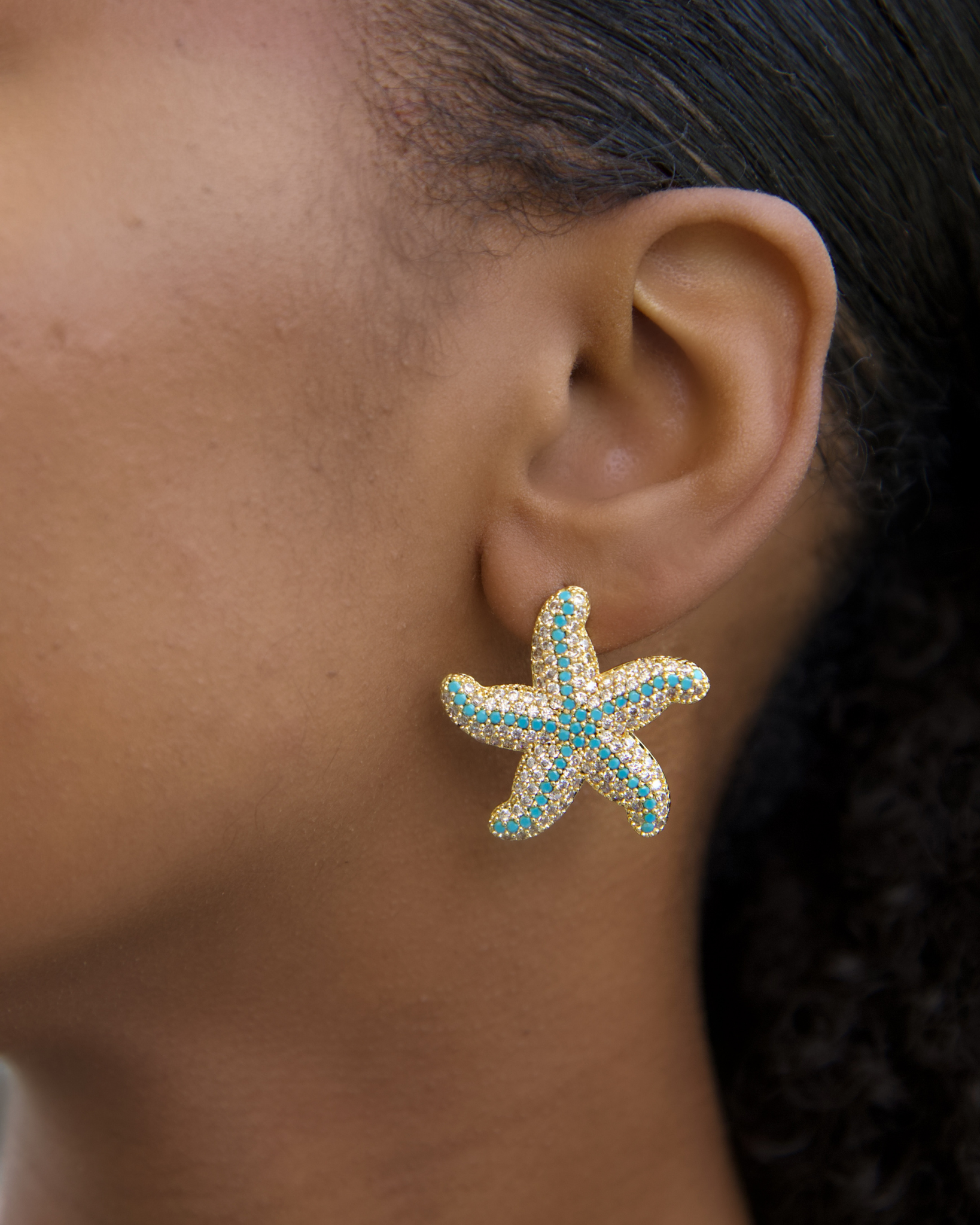Model wearing turquoise starfish earrings