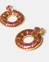 Close-up of pink zircon donut hoop earrings