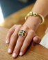 Gold sapphire cocktail ring worn on hand
