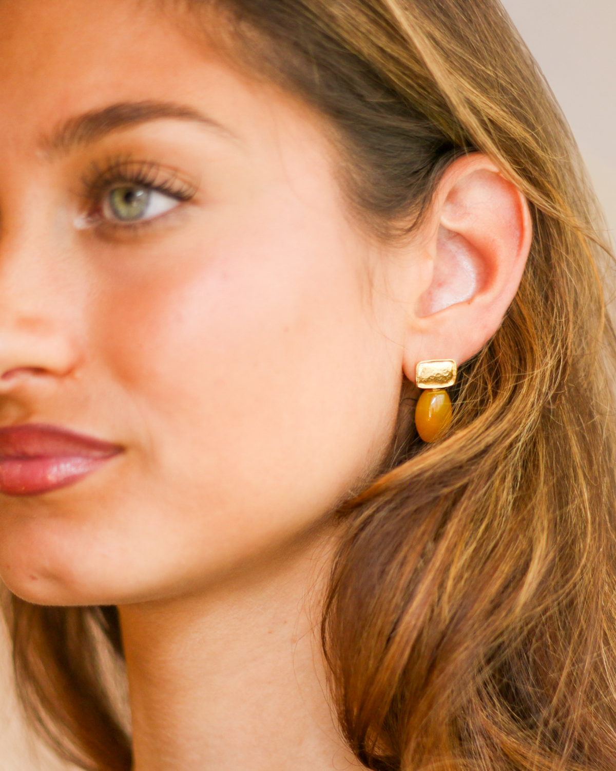 Gold and agate earrings portrait