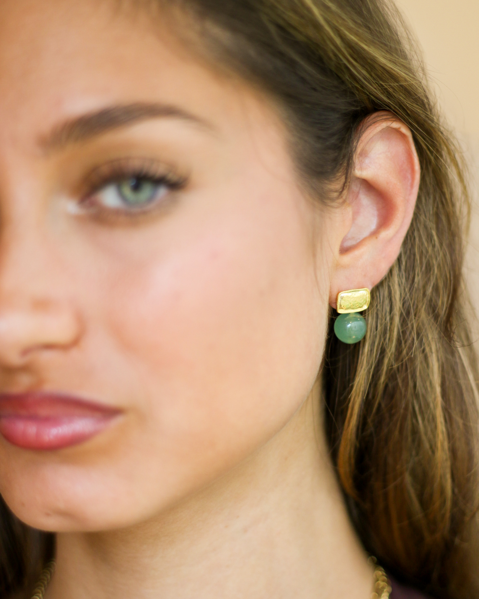Soft green gemstone earrings portrait