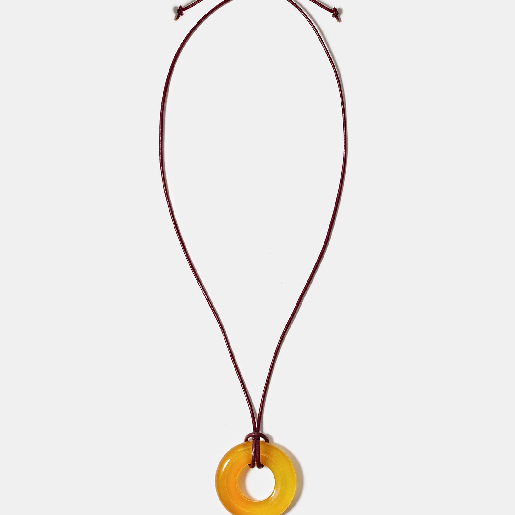 Golden agate donut pendant necklace on adjustable burgundy cord