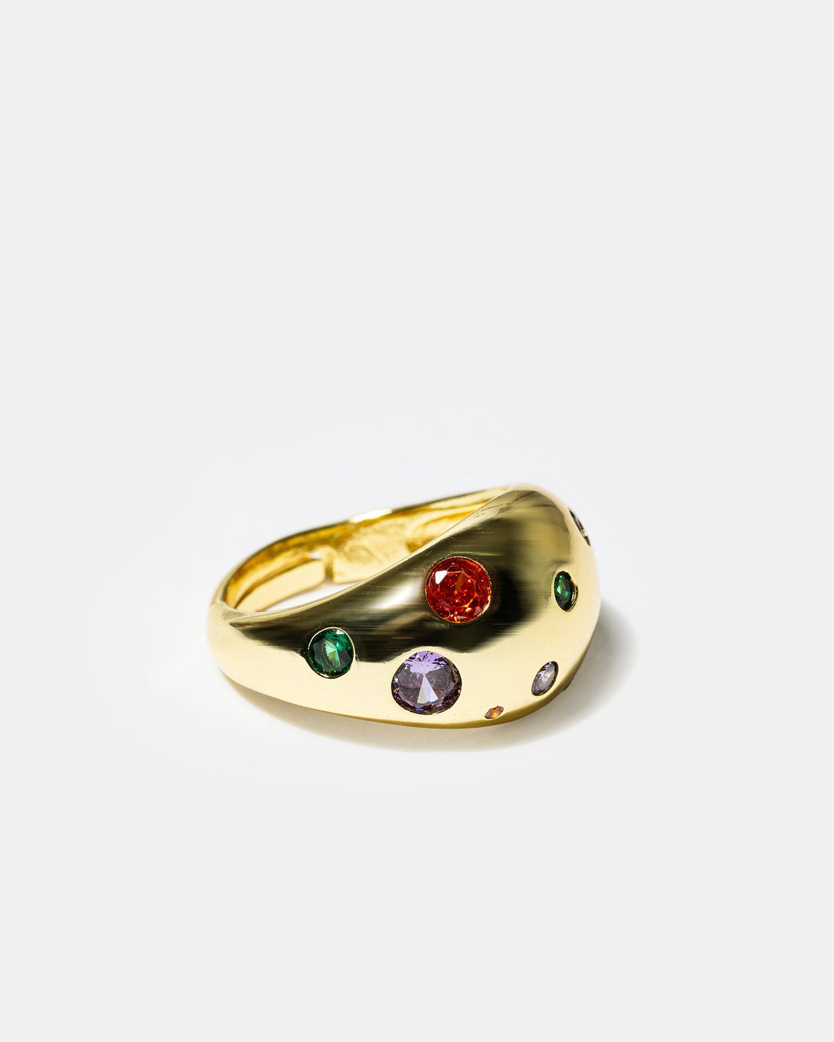 Side view of gold dome cocktail ring with multicolor gemstones