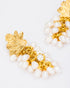 Close-up detail of pearl cluster earrings showcasing gold leaf texture and pearl arrangement
