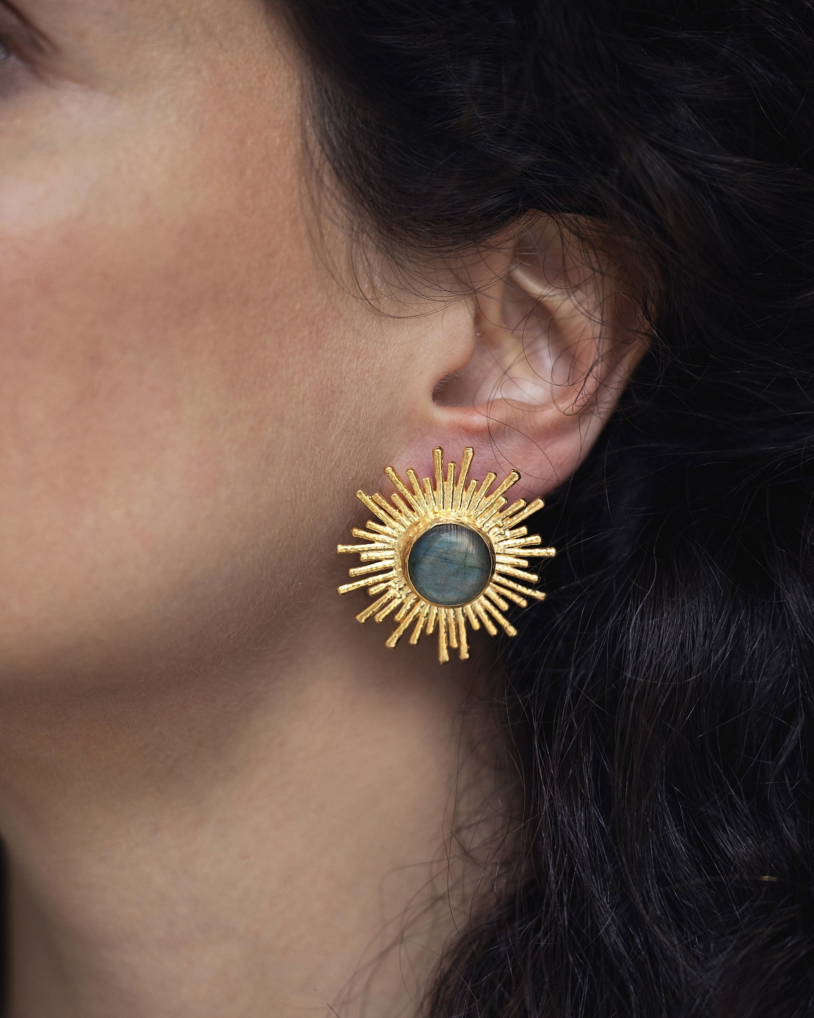 Woman wearing Celestial Radiance labradorite earrings with an elegant celestial-inspired style
