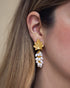 Woman wearing pearl cluster gold leaf earrings with elegant botanical-inspired design