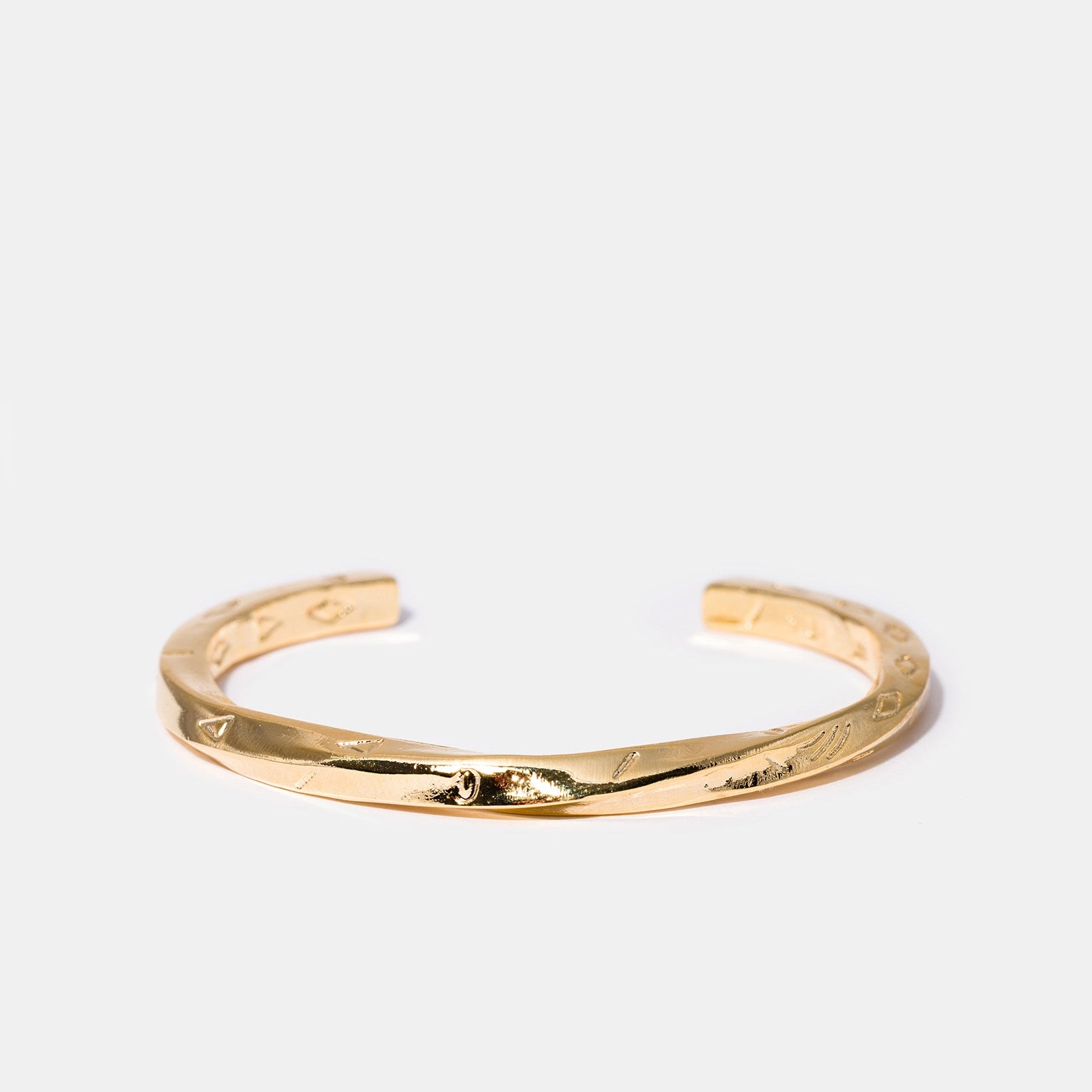 Twisted gold cuff bracelet flatlay