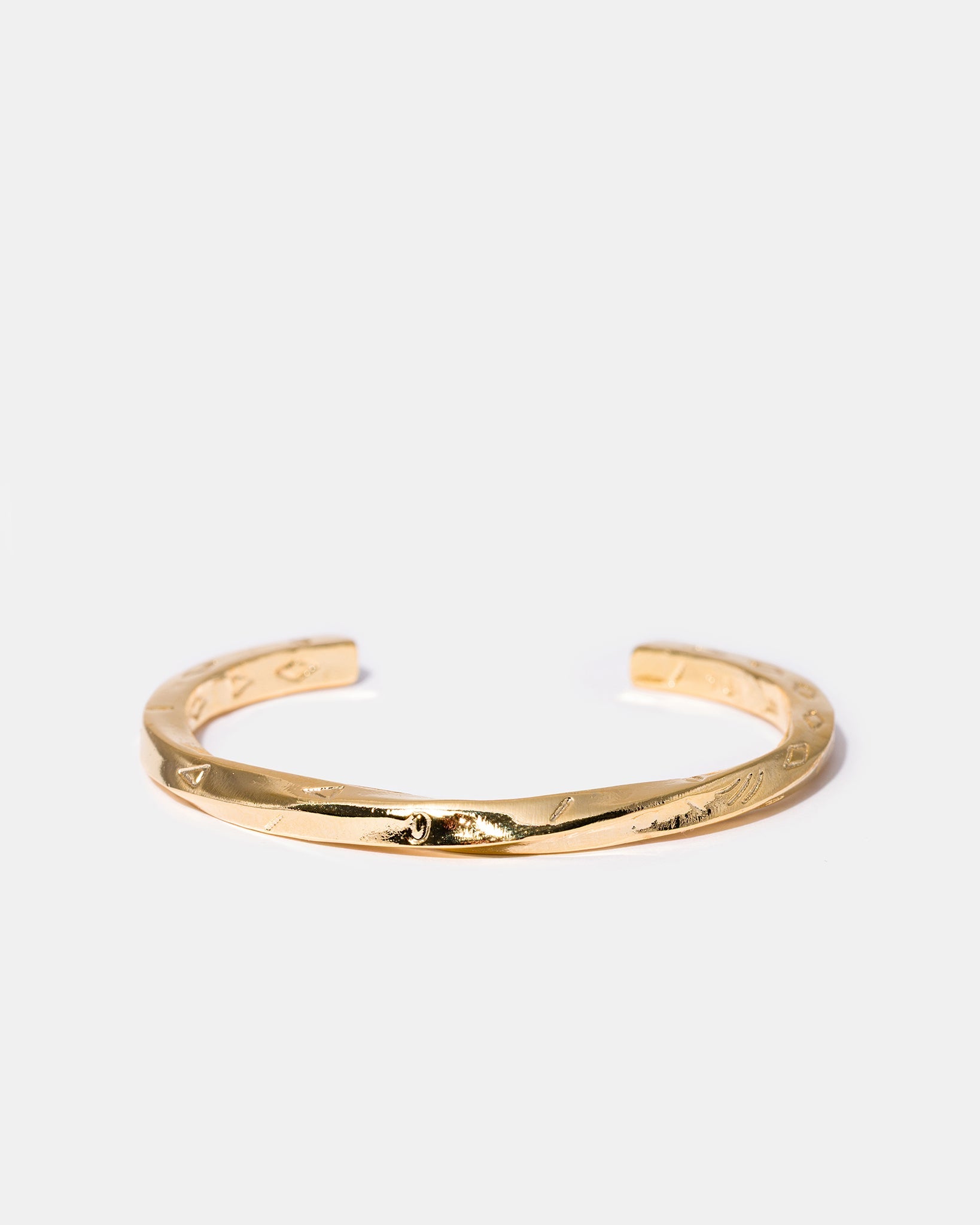 Twisted gold cuff bracelet flatlay