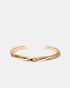 Twisted gold cuff bracelet flatlay