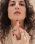 Woman wearing Radiant Ripple statement ring with bold gold-plated design
