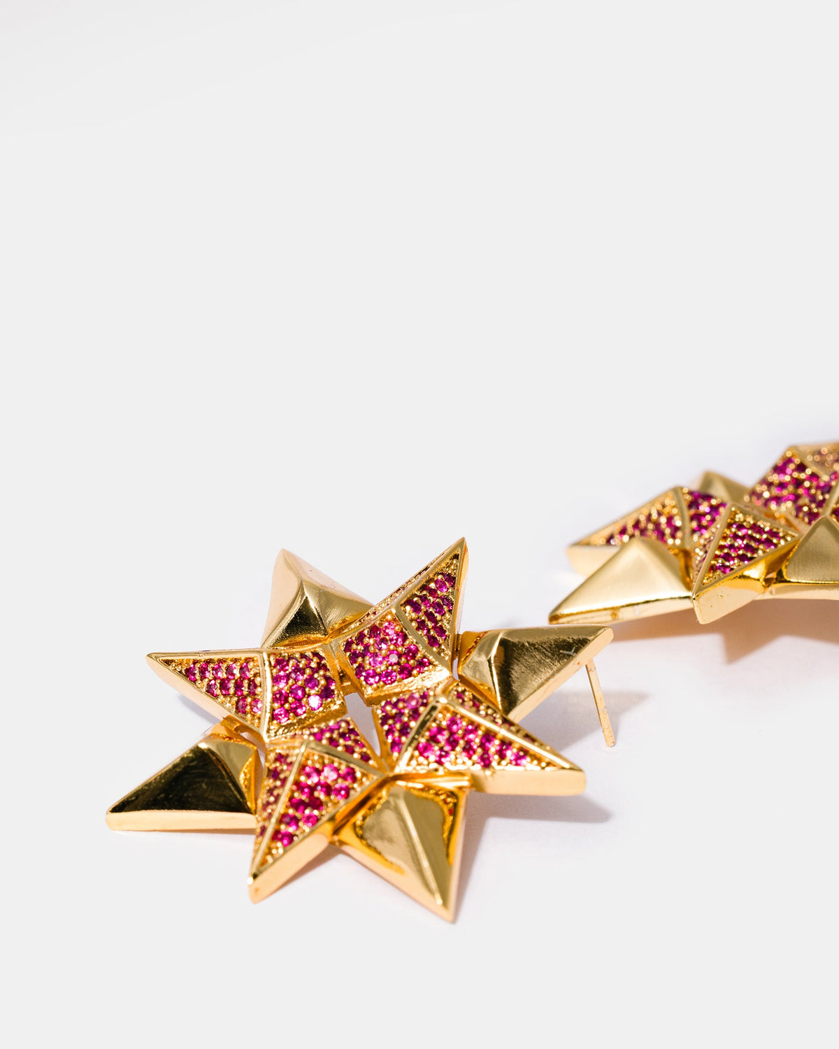 Gold star-shaped earrings close-up