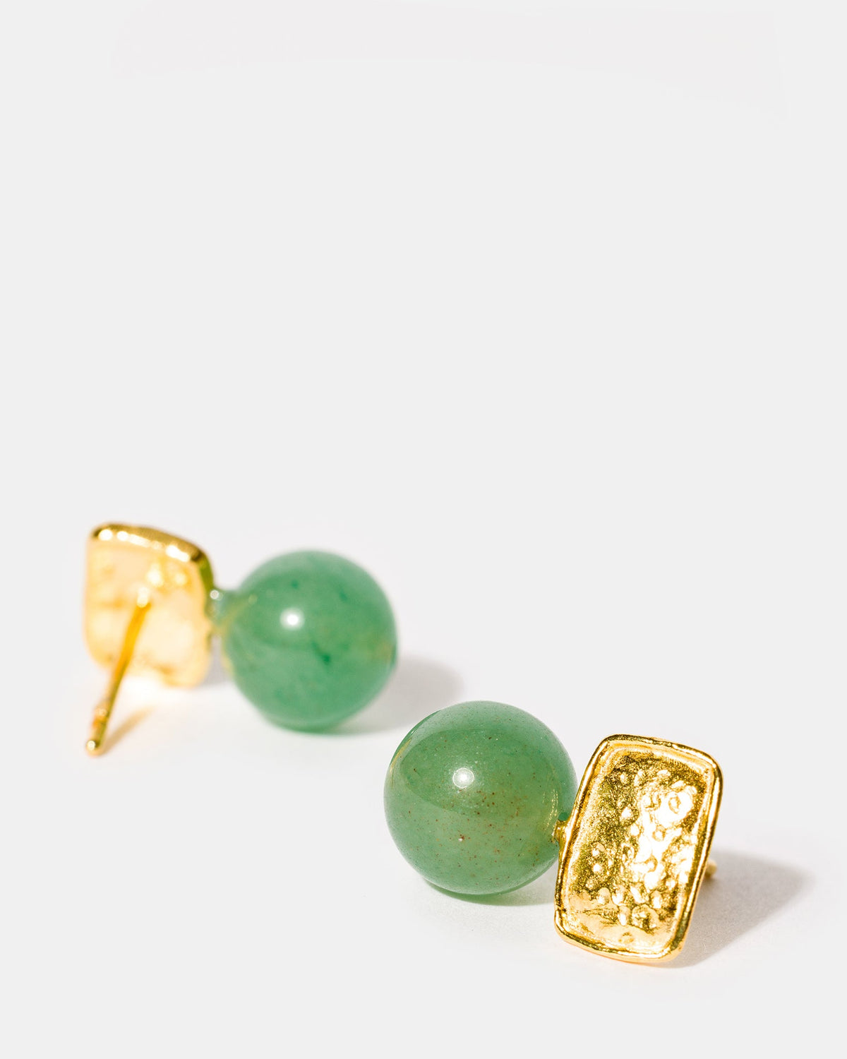 Gold and prehnite earrings close-up