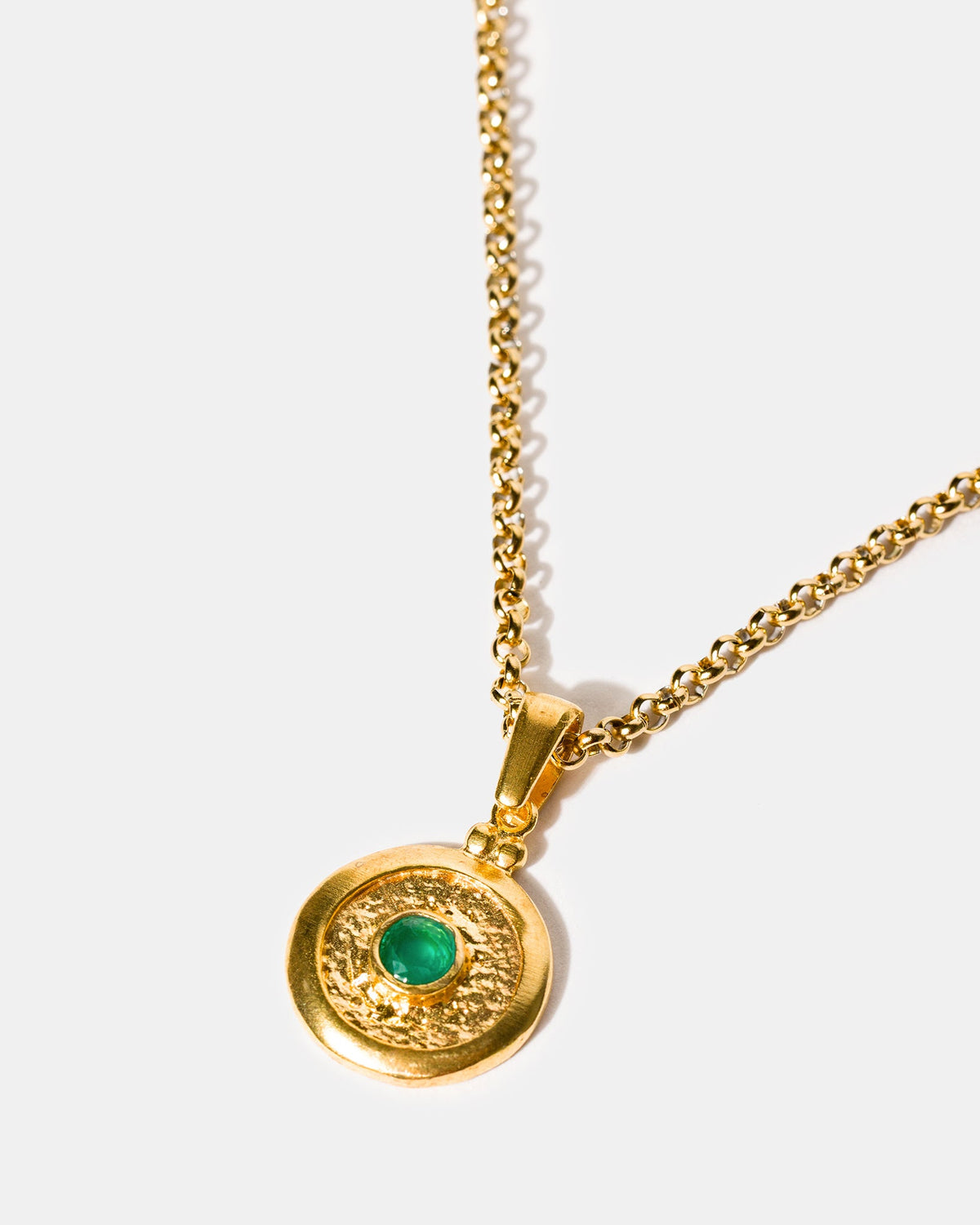 Gold medallion pendant necklace with emerald green stone
