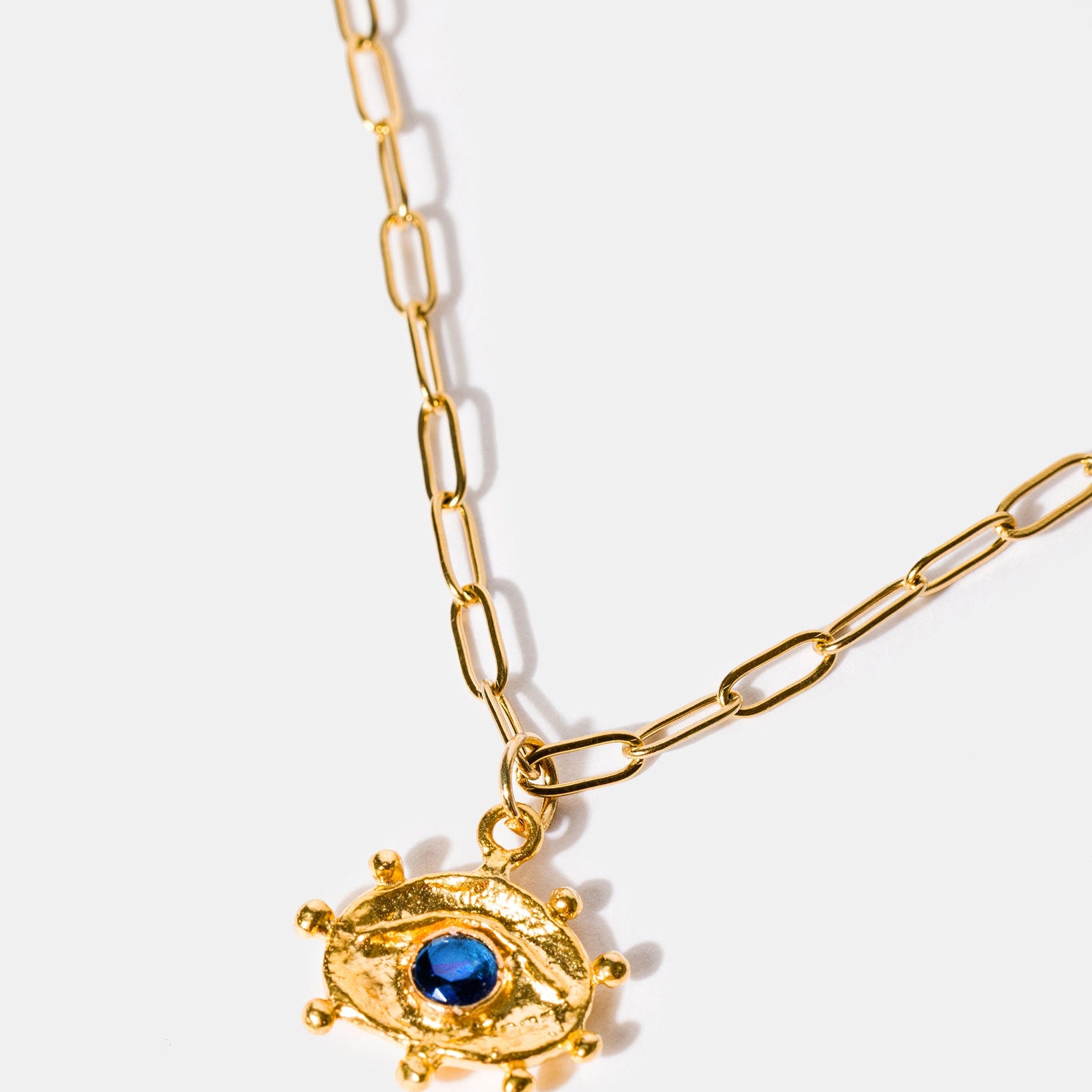 Gold eye talisman pendant necklace with sapphire blue stone