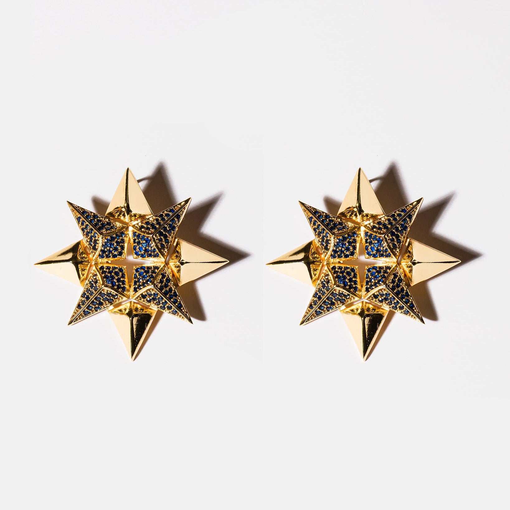 Sapphire starburst earrings flatlay