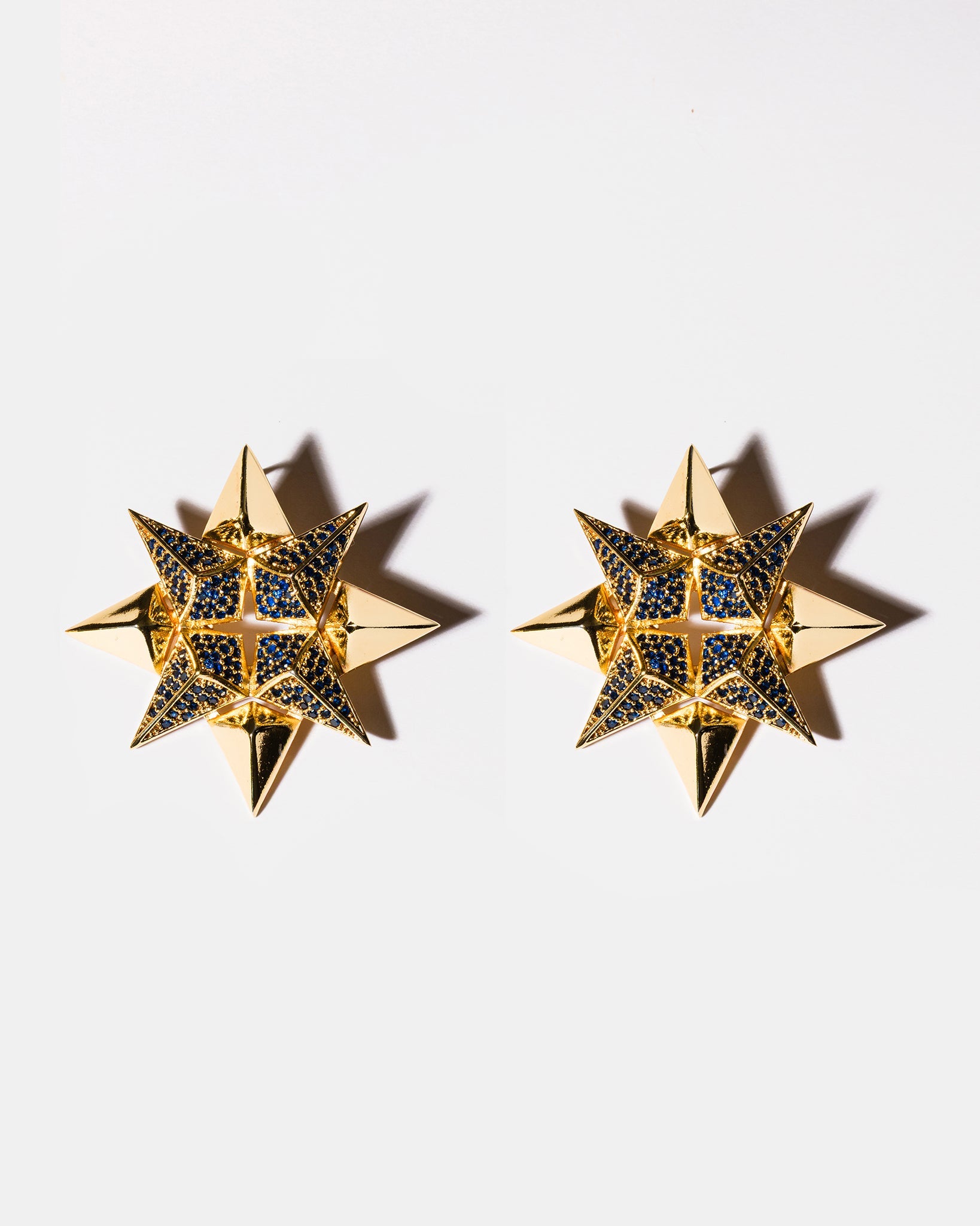 Sapphire starburst earrings flatlay