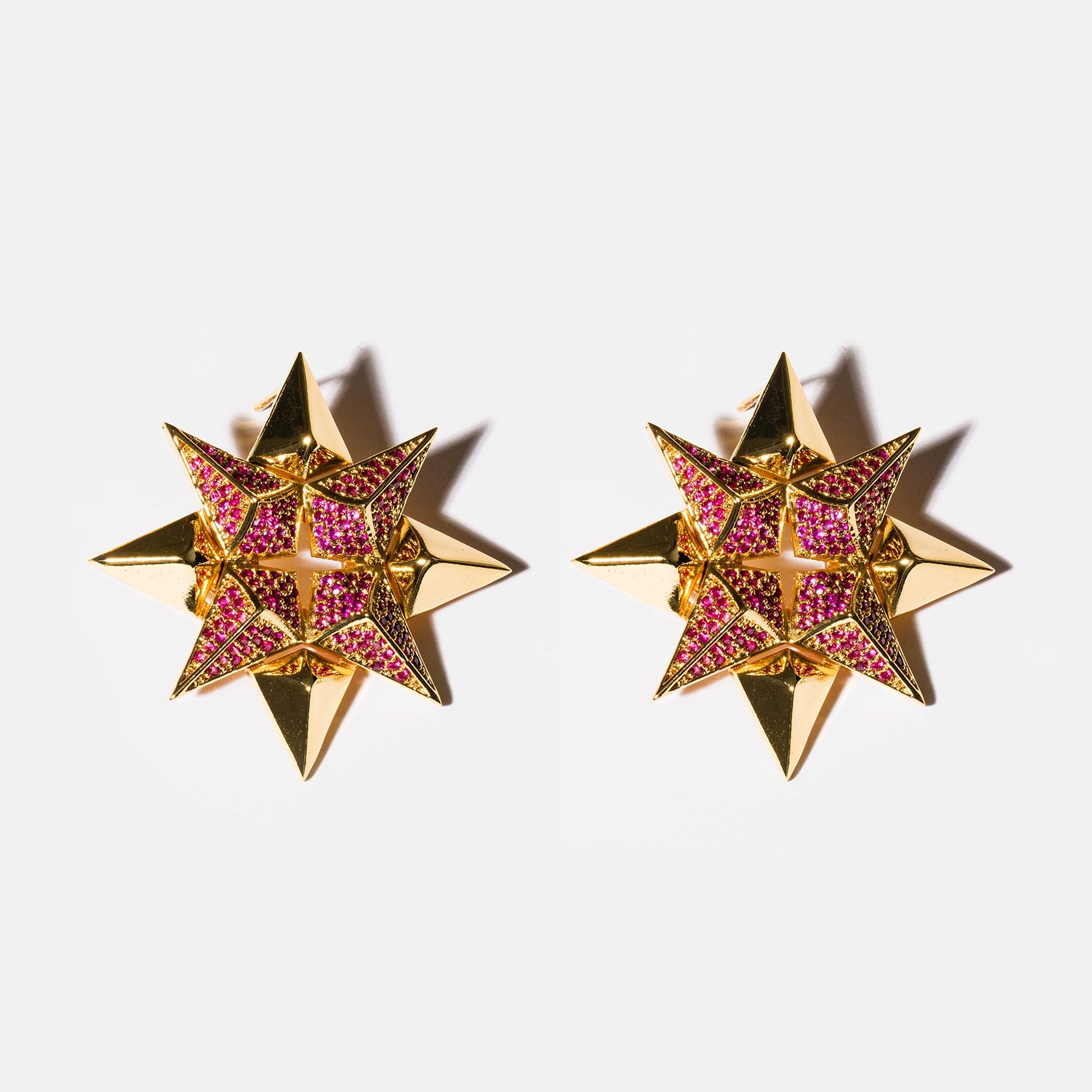 Ruby starburst earrings flatlay