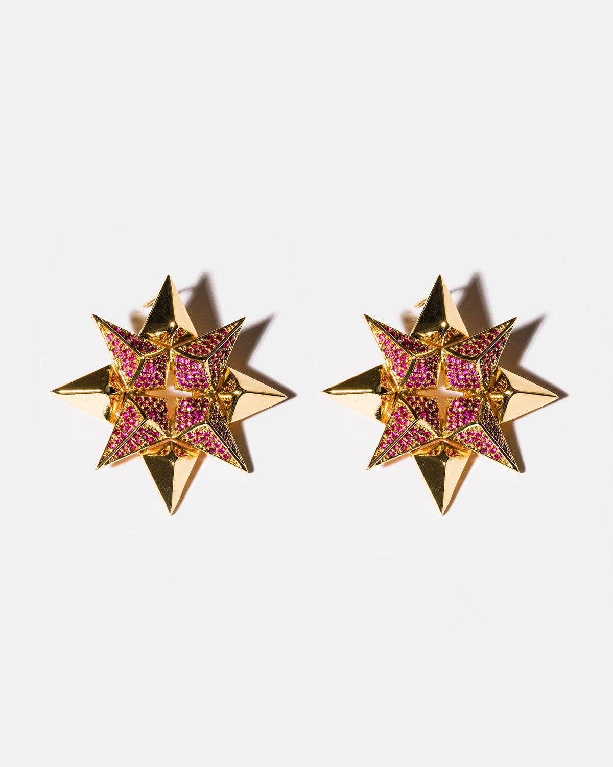 Ruby starburst earrings flatlay