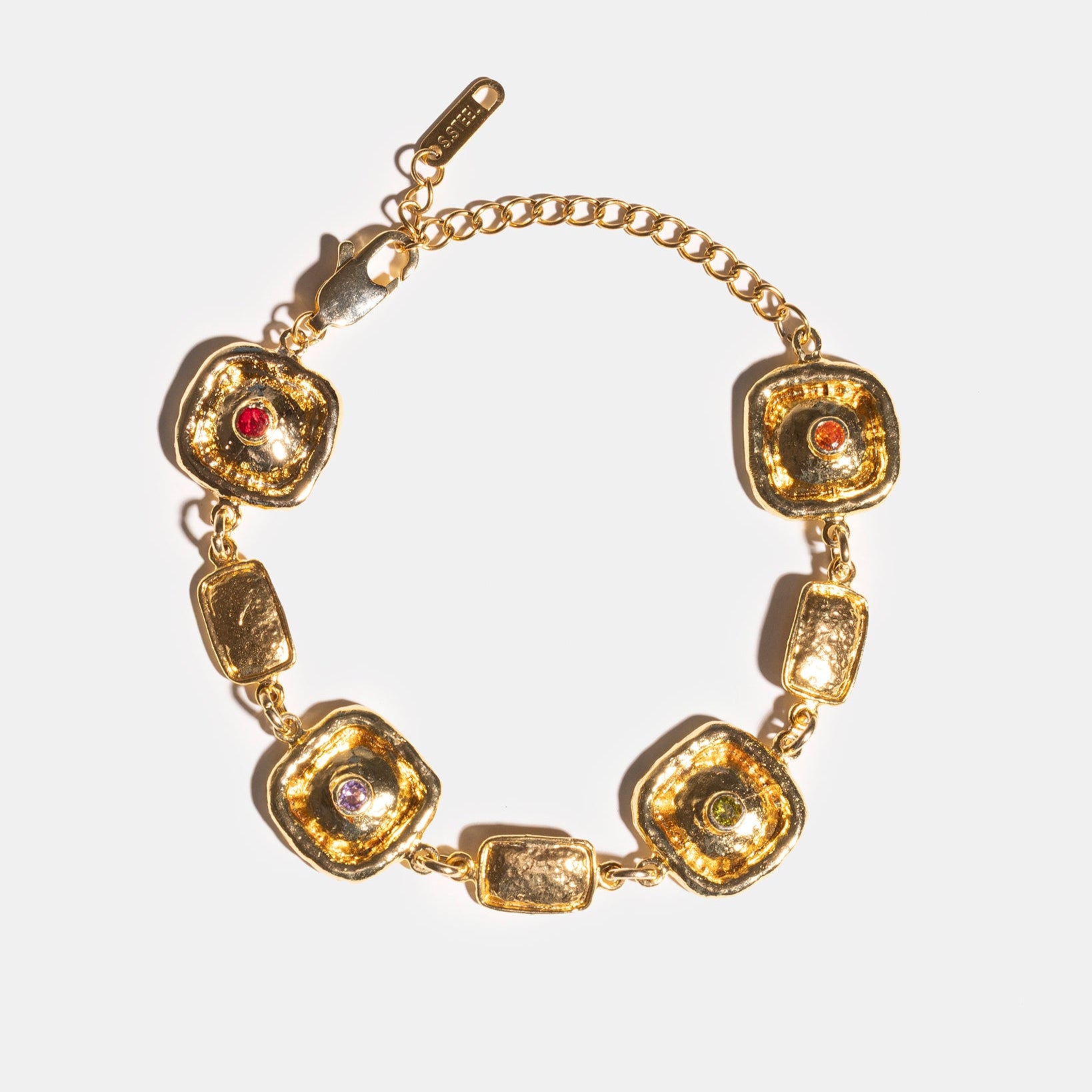 Gold medallion bracelet flatlay