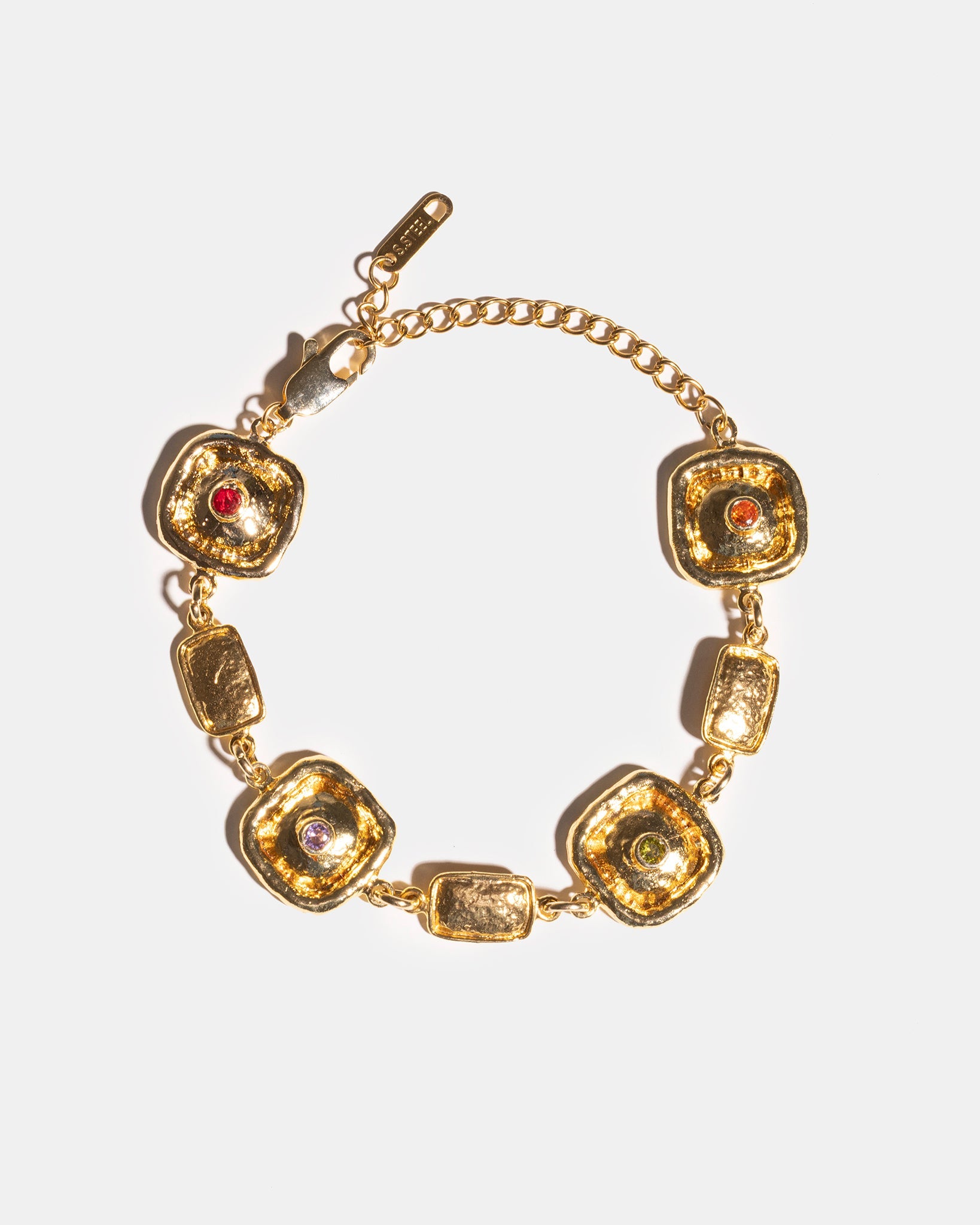 Gold medallion bracelet flatlay