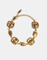 Gold medallion bracelet flatlay