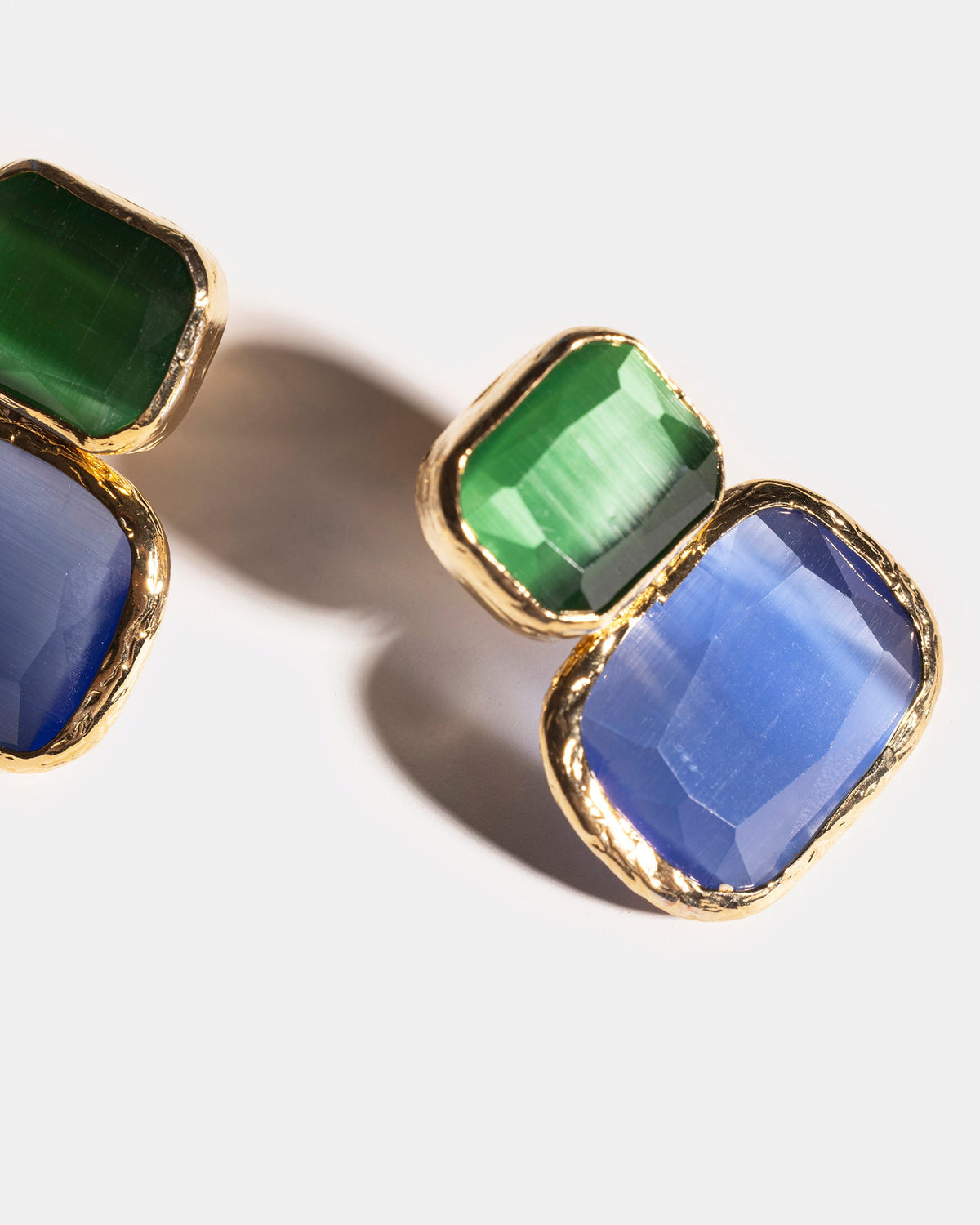 Blue and green gemstone earrings close-up