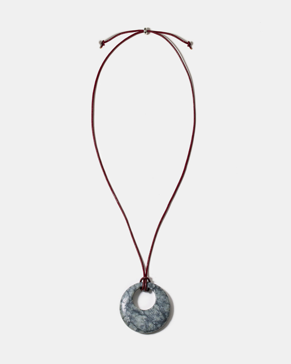 Black rhodonite donut pendant necklace on adjustable burgundy cord