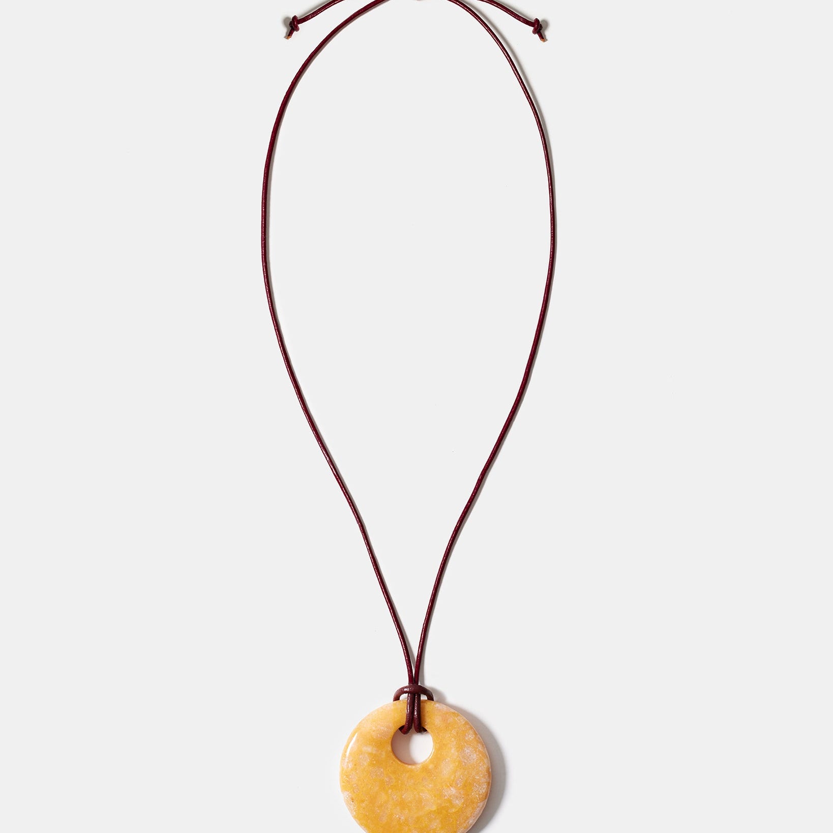 Yellow calcite donut pendant necklace on adjustable burgundy cord