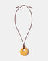 Yellow calcite donut pendant necklace on adjustable burgundy cord