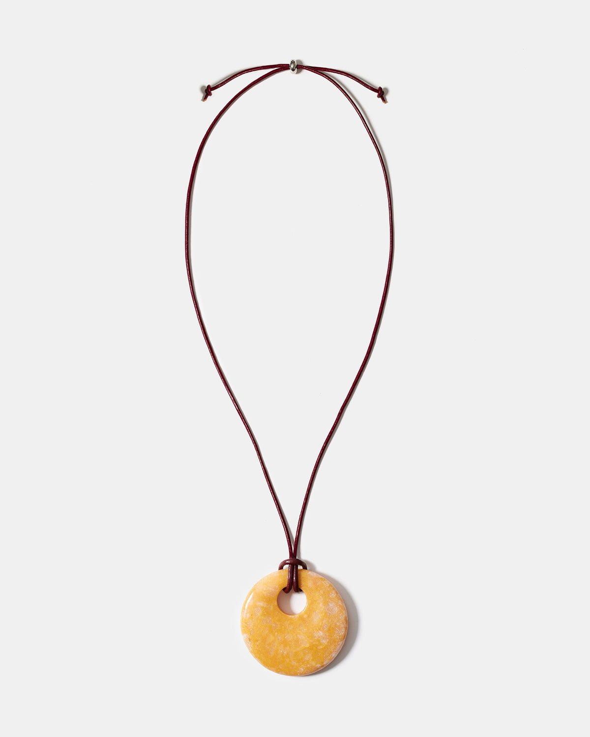 Yellow calcite donut pendant necklace on adjustable burgundy cord