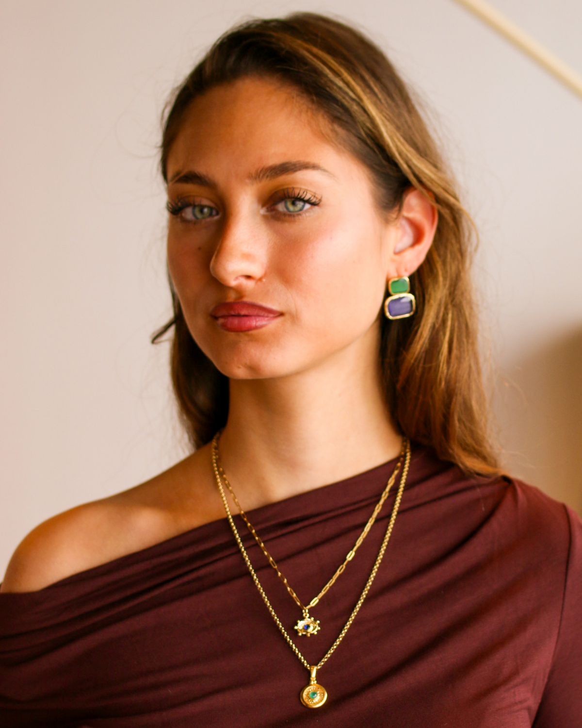 Vintage-inspired emerald medallion necklace styling