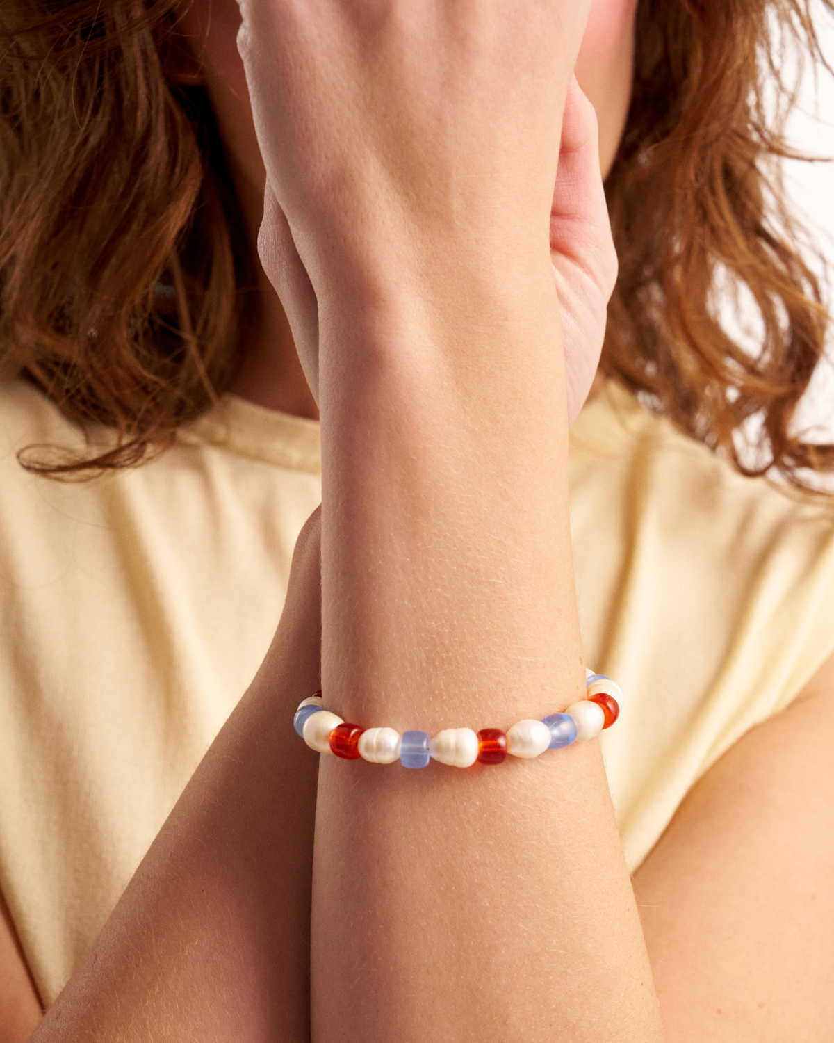 Close-up of pastel pearl and glass bead bracelet