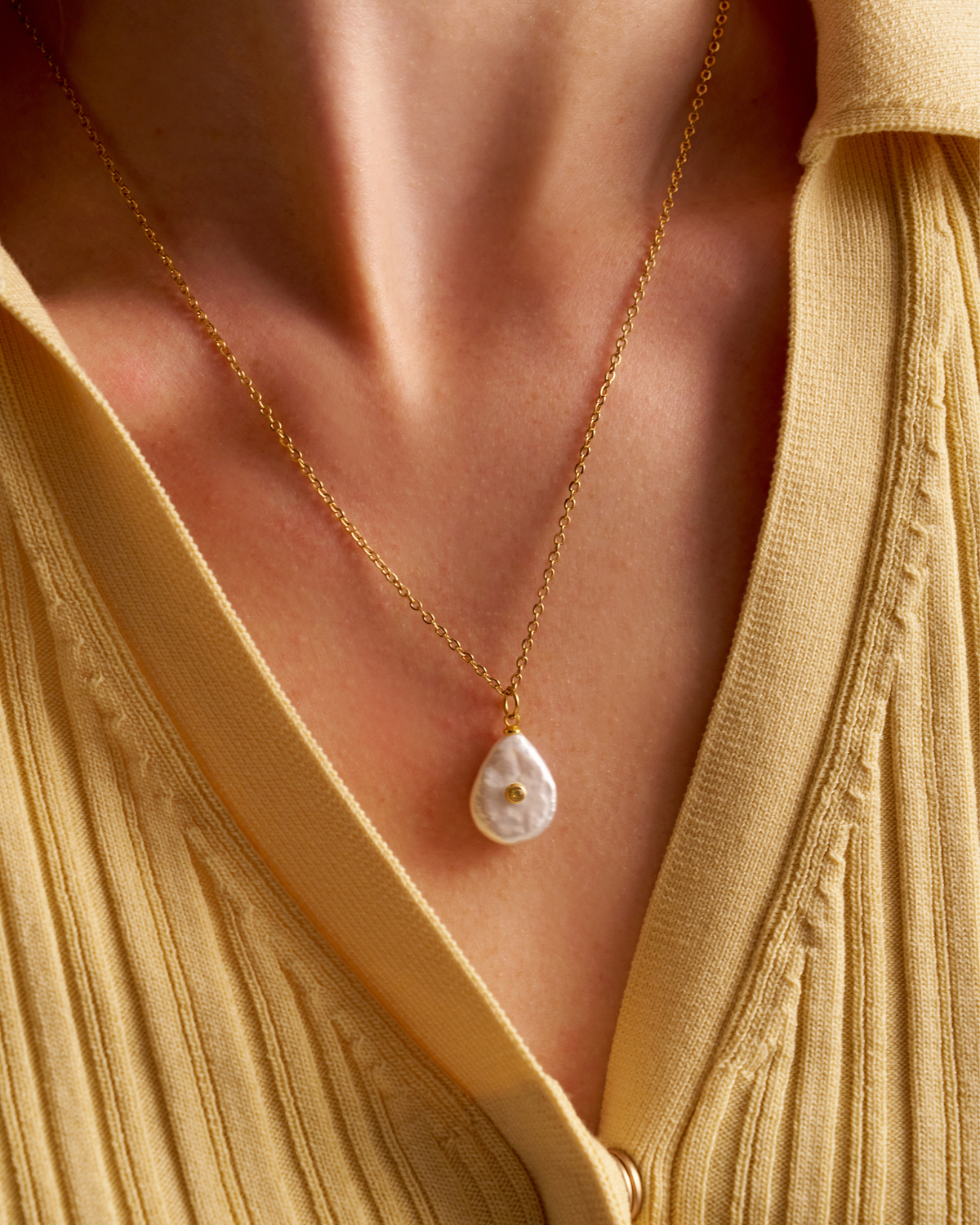 Woman wearing delicate pearl necklace