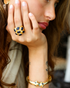 Model wearing gold sapphire multi-gemstone cocktail ring