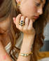 Gold sapphire statement ring styled with layered jewelry