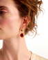 Close-up lifestyle image of pomegranate-inspired red gemstone earrings