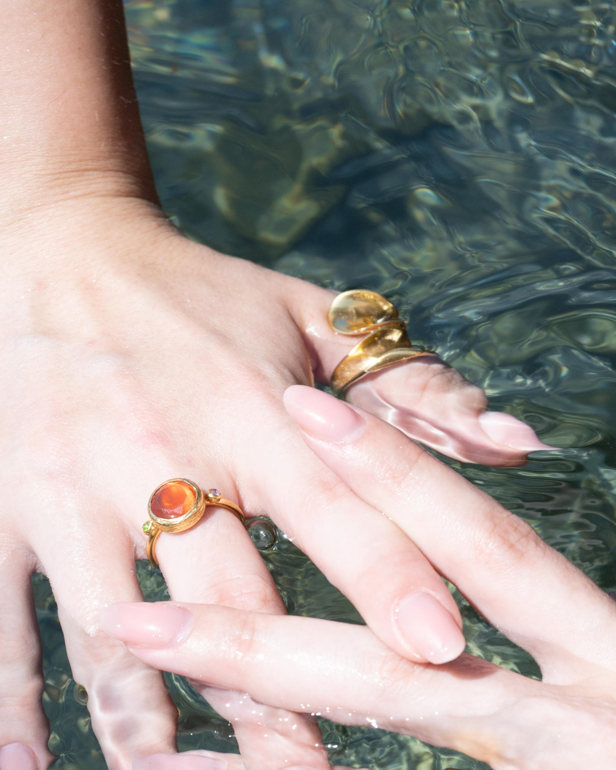 Woman wearing Amber Glow Cat's Eye statement ring with elegant styling