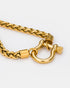Close-up of gold chain necklace and toggle clasp detail