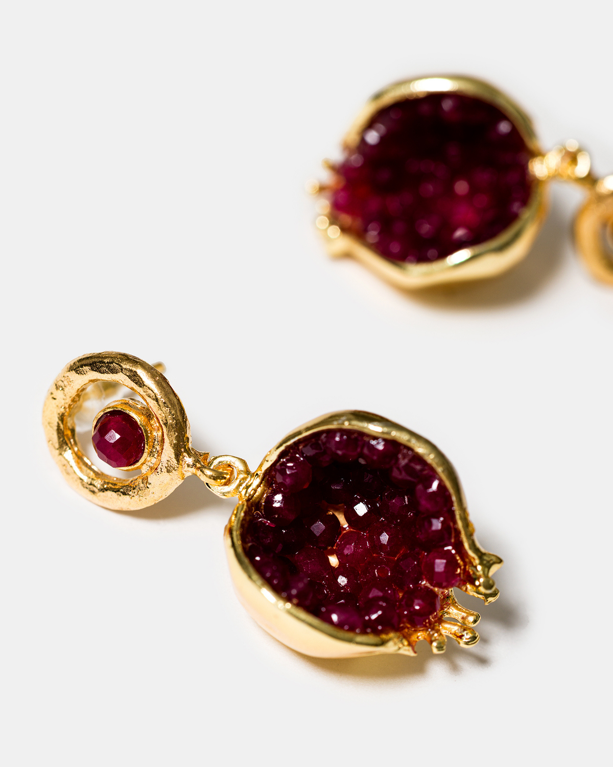 Product detail of red jade earrings highlighting gemstone and gold-plated setting