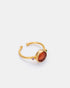 Close-up detail of amber cat eye ring featuring a gold-plated adjustable band