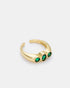 Close-up side view of Trinity Spark ring showcasing triple green zircon details