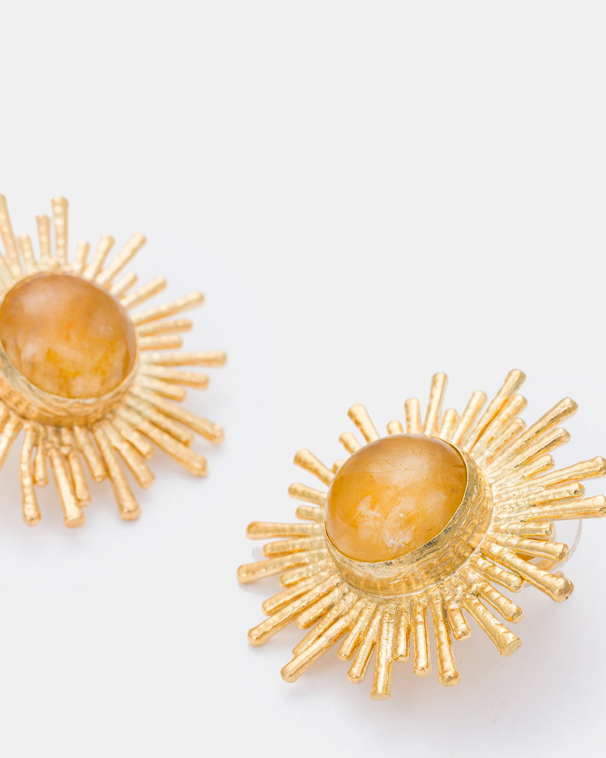 Close-up detail of celestial citrine earrings showing radiant sun-inspired design