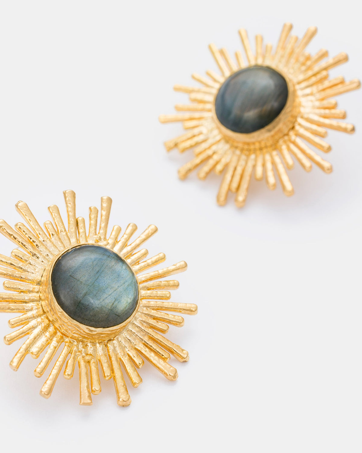 Close-up detail of gold sunburst earrings showcasing labradorite stones and radiant sunburst design