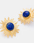 Close-up detail of gold sunburst earrings showcasing vivid blue lapis lazuli stones