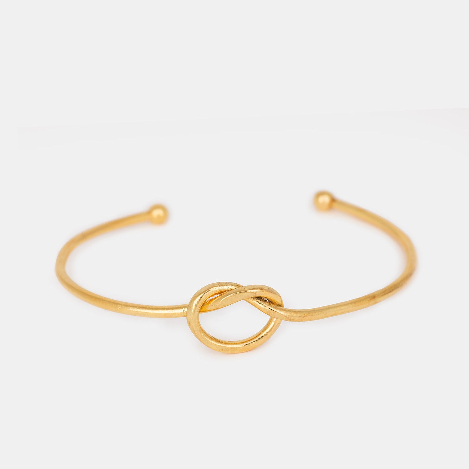 Gold-plated knot bangle bracelet with minimalist design