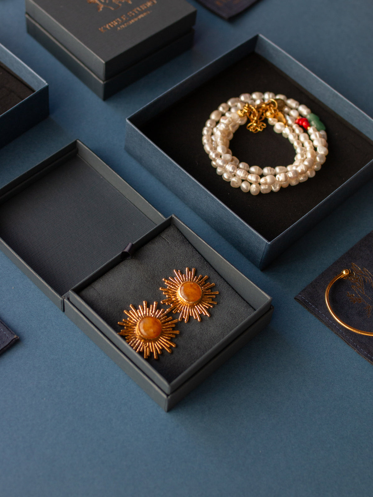 Styled flat lay of citrine sunburst earrings with luxury jewelry presentation